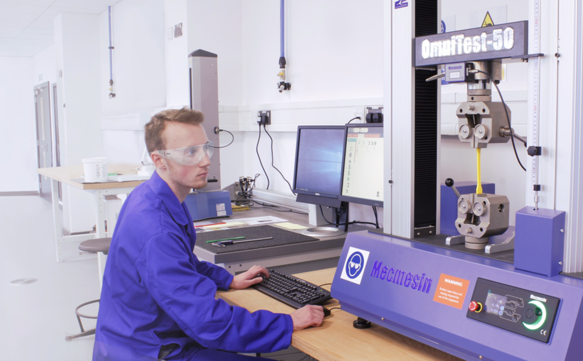 University student testing physical properties on a Mecmesin Universal Testing Machine (UTM) for materials testing