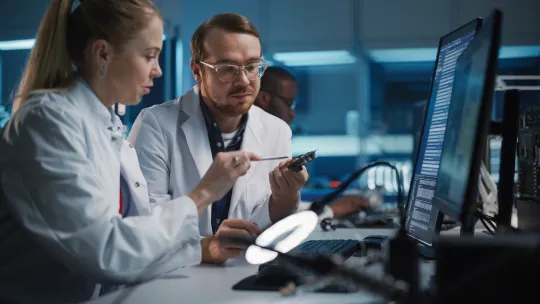 Stock photo of support engineer providing training to a lab technician