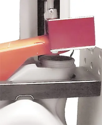 Oil container dispensing cap push-to-flip and removal test fixture close up