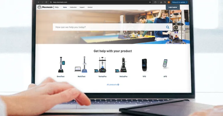 Laptop on a desk with browser viewing Mecmesin help website