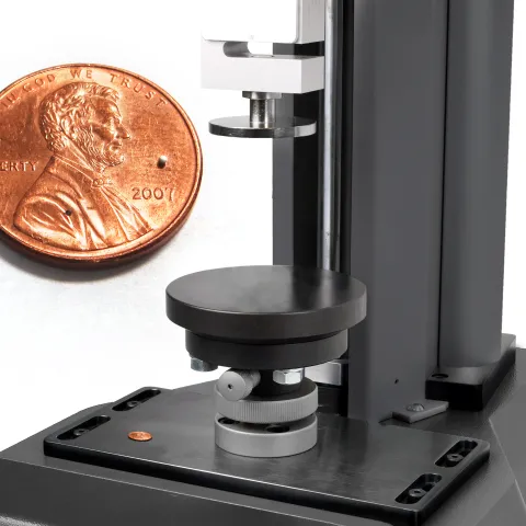 Single catalytic pellet on a coin and compression tester with self-levelling plates