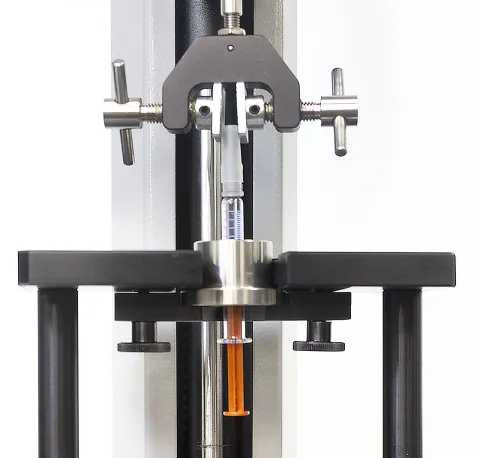 Dual-action vice grip and syringe holder sleeve fixtures to apply tension to pull-off the tip cap