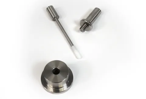 Compression loading pin and syringe holder sleeve fixtures to destructively test a glass syringe barrel flange