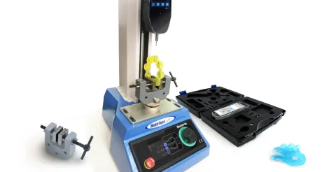 Puncture testing a baby chew toy with a gauge, compression tester with needle probe and vice grip