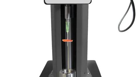 Punctured medical sharps container material specimen for resistance testing