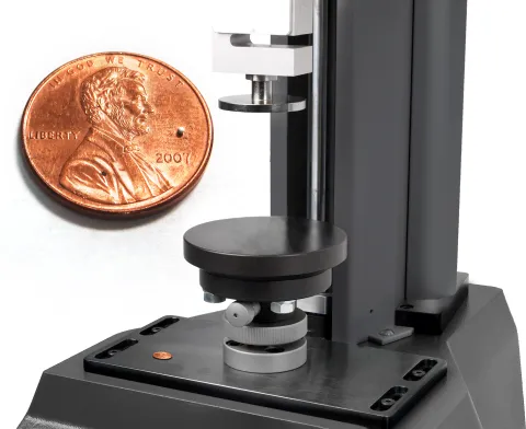 Single catalytic pellet on a coin and compression tester with self-levelling plates