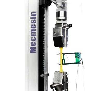 Plastic dumbbell material specimen with a contact extensometer attached